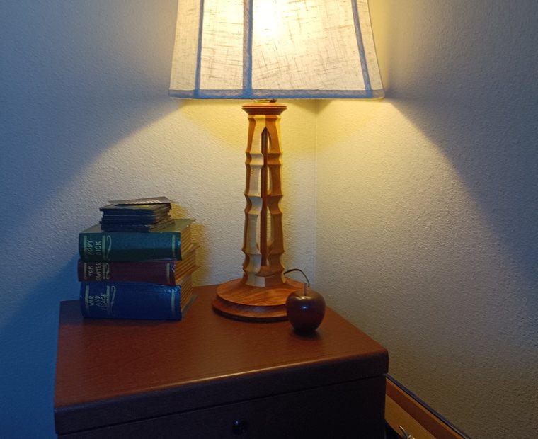 Handcrafted turned wood lamp styled in a room