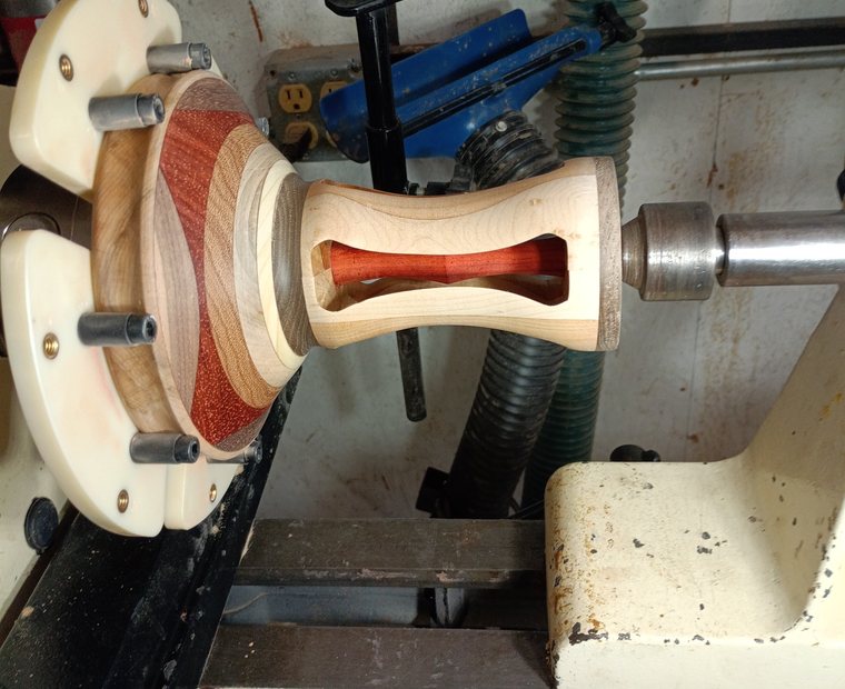Turned wood lamp base in progress on the lathe